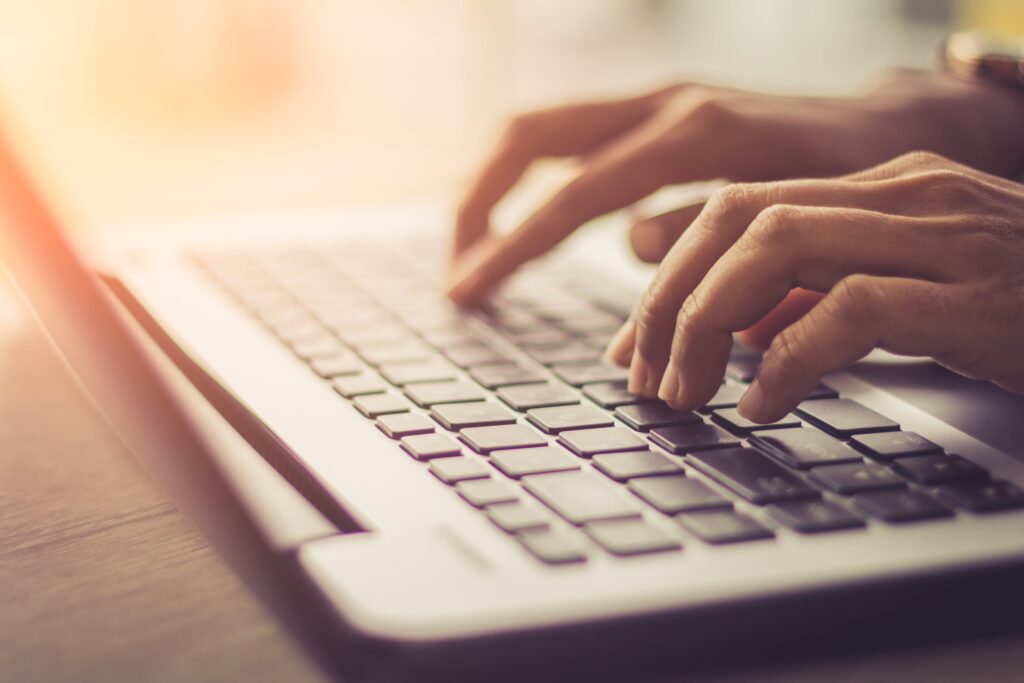 hands typing on a computer