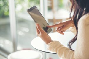 woman looking at tablet computer