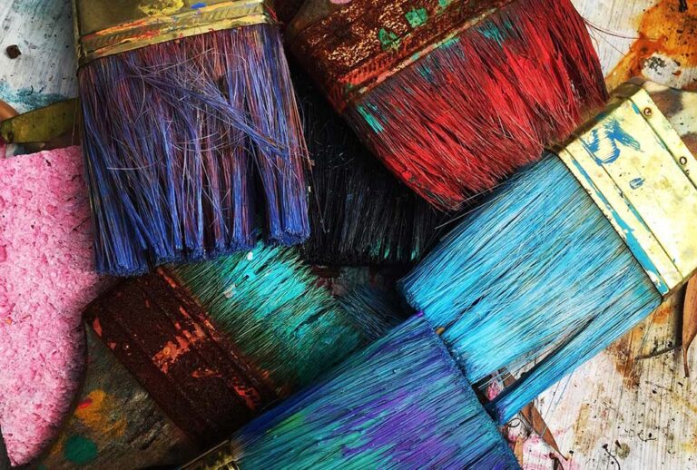 Image of paint brushes stained with different pigments