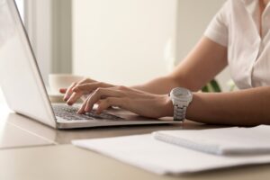 Woman typing on a laptop computer