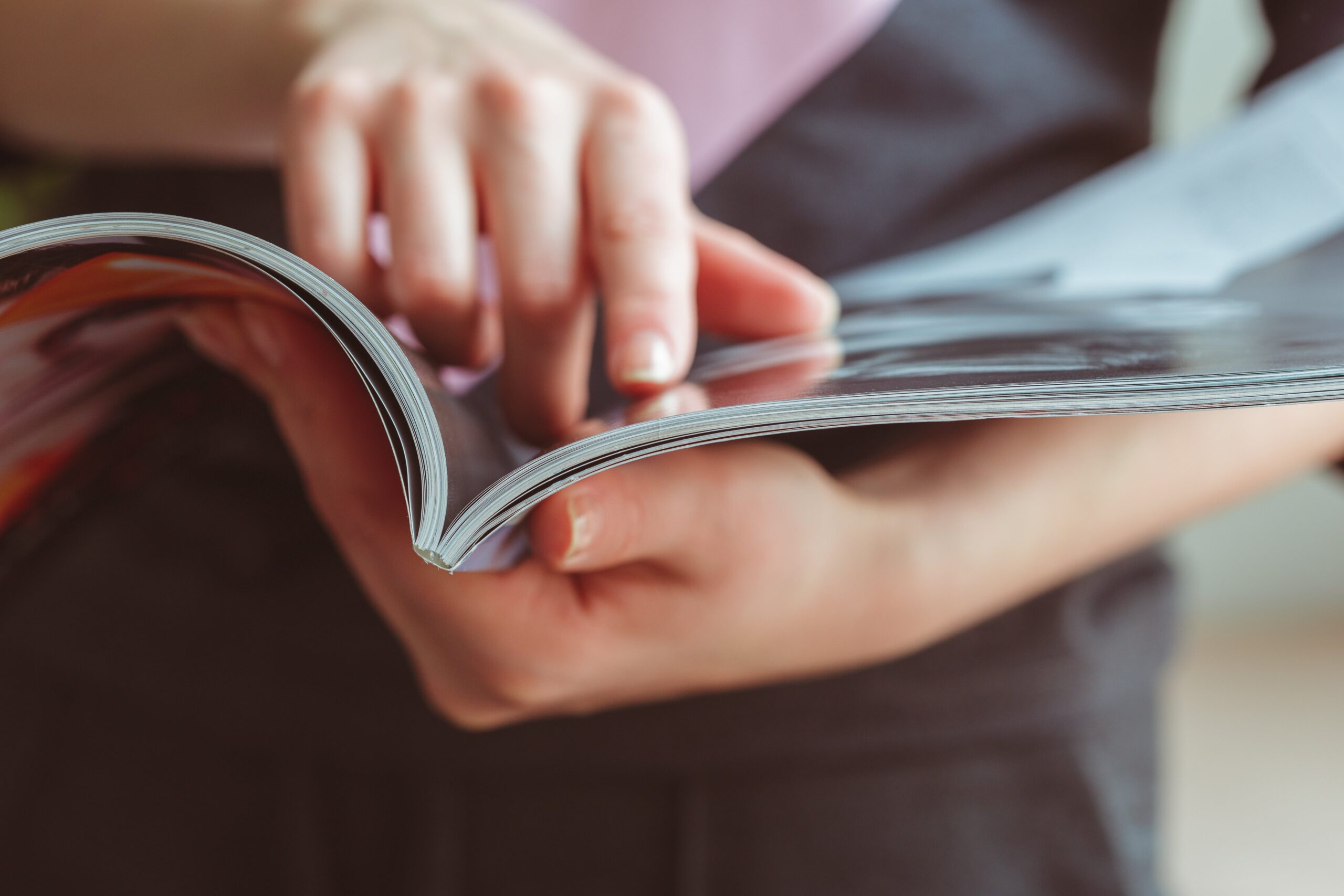 Hands pointing to something in a magazine