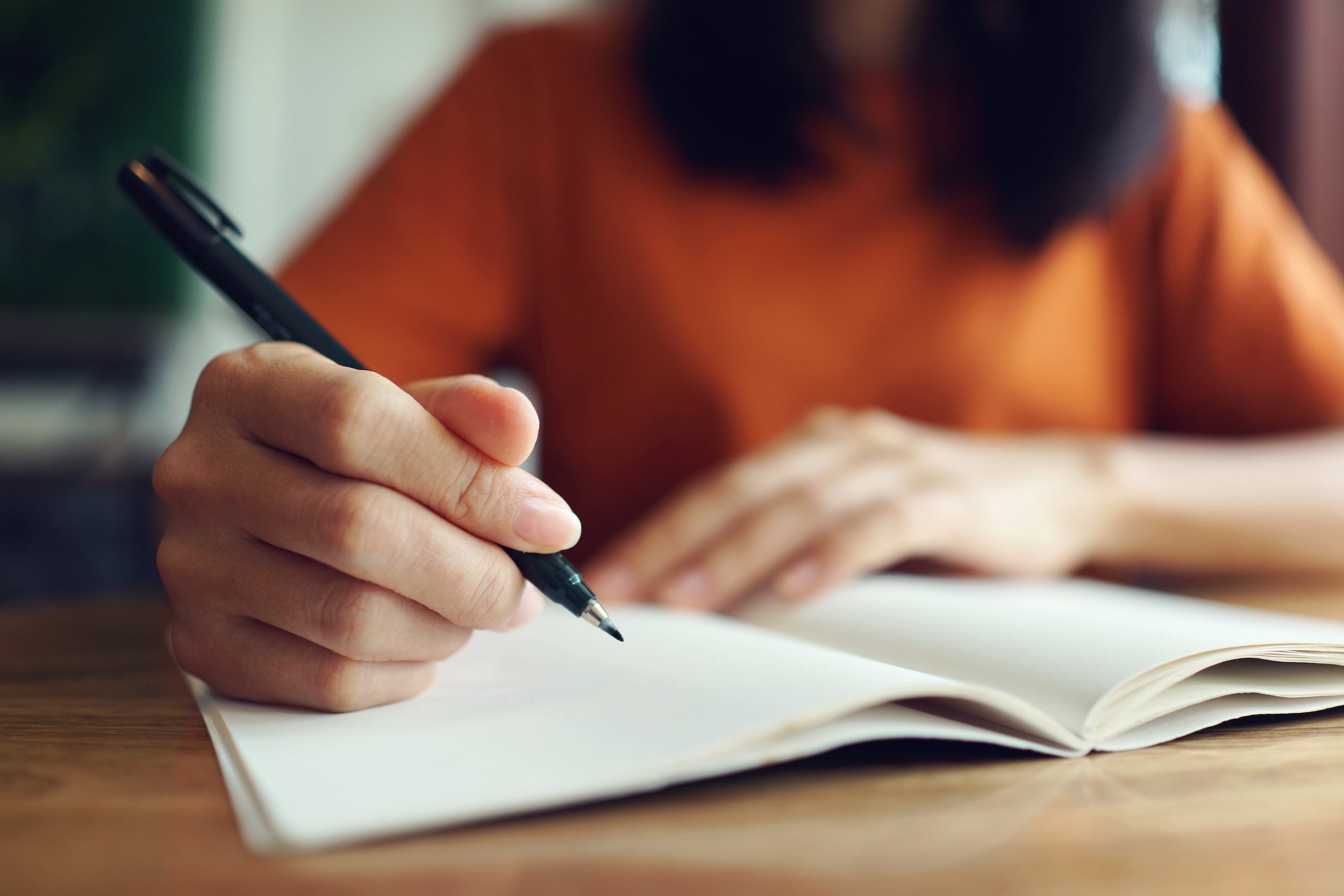 Woman writing in notebook